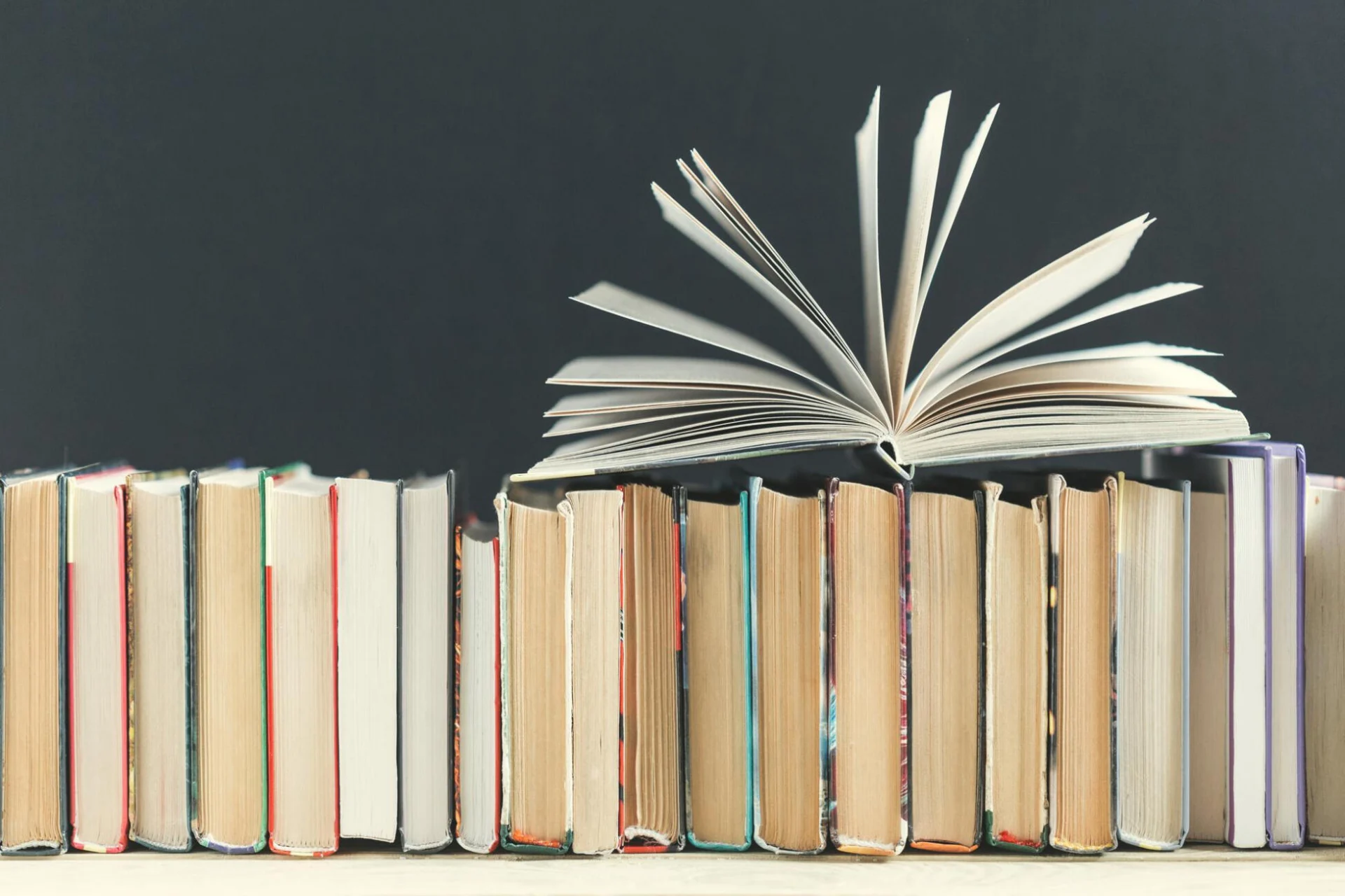 Books line up open pages